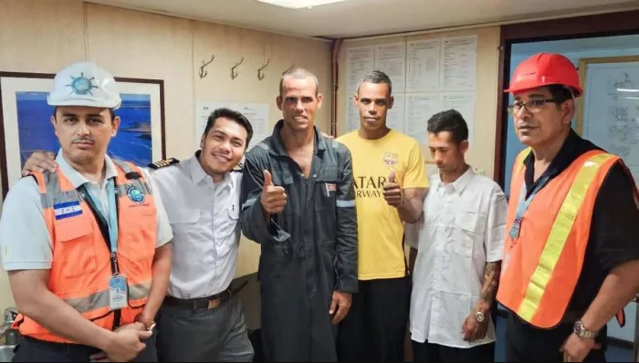 MV Impala Capt. Nilgie Morandarte (second from left) with the three rescued fishermen (third to fifth) and immigration port authorities of Honduras.
